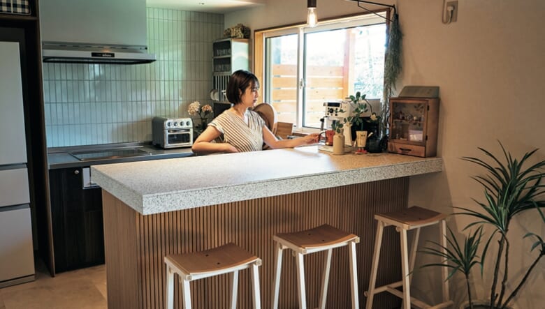 キッチンカウンターは、カフェをイメージしてハイチェアを設置。それにともなってカウンターも高めに設定している。「リビングからキッチンの内部が見えにくいのもいいですね」。