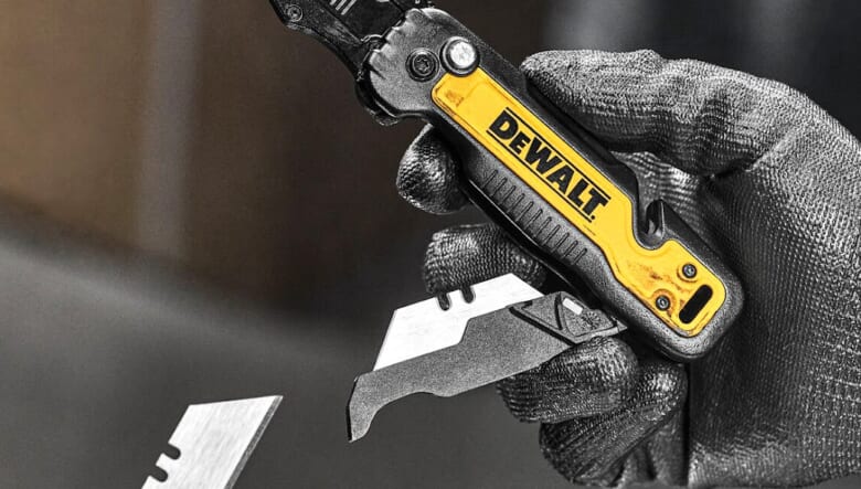 DEWALT knife being flipped open with one handed push to release
