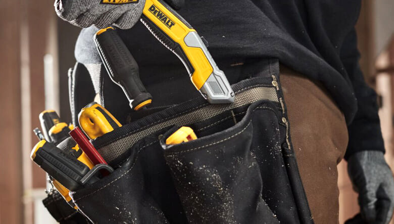 Worker removing DEWALT® DWHT10998 Utility Knife from work belt pocket